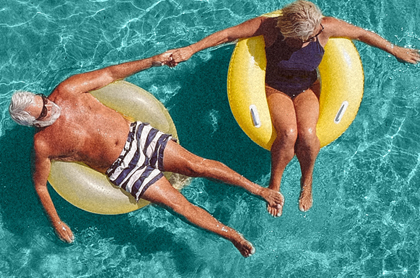Retired couple sitting in the swimming pool